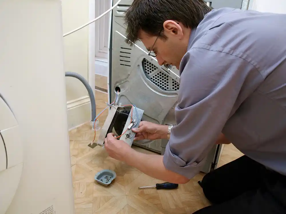 Appliance technician working on a dryer circuit board